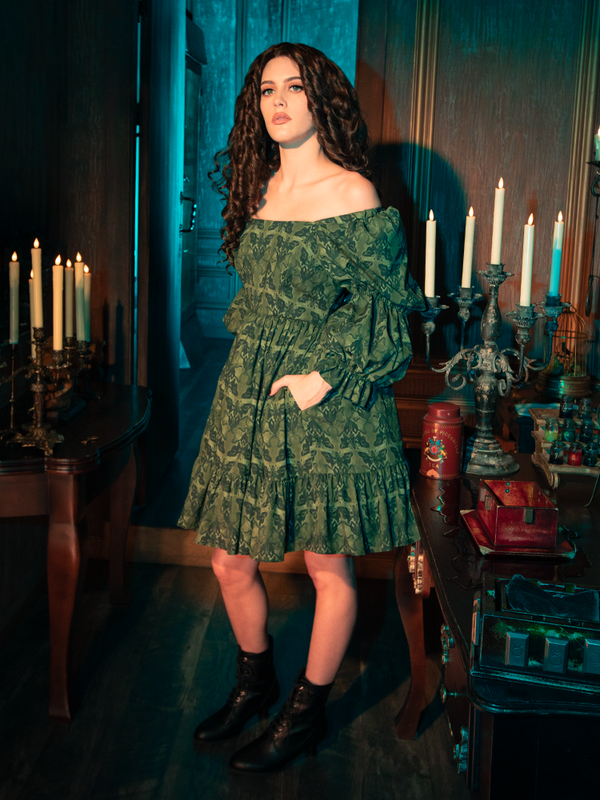 The whispering wings of moths, captured in the intricate design of the Allerdale Moth Wallpaper Babydoll Dress, evoke a sense of ephemeral beauty. The olive color, rich and earthy, grounds the ethereal design, creating a piece that is as grounded as it is whimsical. This dress is a testament to the allure of the Gothic, inviting the wearer to explore the depths of their own imagination.