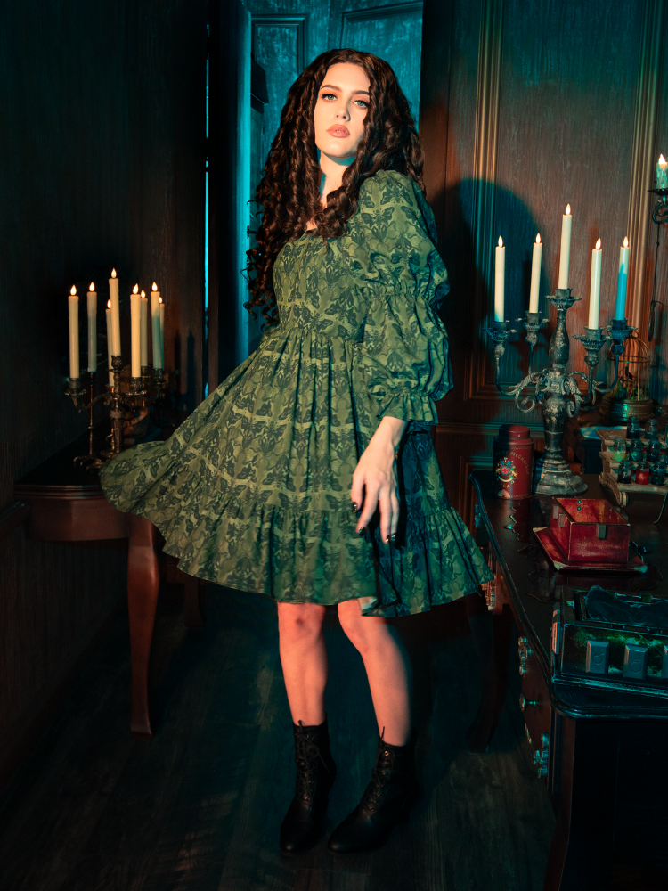 Wrapped in the Allerdale Moth Wallpaper Babydoll Dress, you are an embodiment of the eternal night. The olive fabric, as deep and mysterious as the forest at midnight, is adorned with moths that navigate by the moon's glow. This dress is a celebration of the unseen, the untold, and the unforgettable.