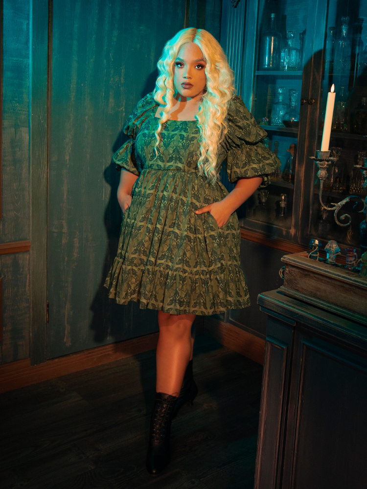 The Allerdale Moth Wallpaper Babydoll Dress casts the wearer in mystic shadows, its olive hue and moth motifs creating an aura of intrigue. This dress, with its fluid lines and ethereal silhouette, is a testament to the power of the gothic aesthetic, inviting onlookers into a world where mystery reigns supreme.