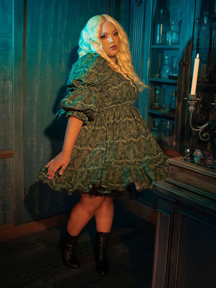 The Allerdale Moth Wallpaper Babydoll Dress, with its soft olive hue and haunting moth print, invites you into a gothic reverie. The babydoll cut, both innocent and provocative, whispers tales of forgotten mansions and secret gardens. Wearing this dress, you become part of a narrative that celebrates the beauty found in darkness.