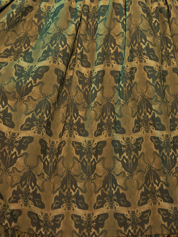 Shrouded in the enigmatic elegance of the olive-toned fabric, the Allerdale Moth Wallpaper Babydoll Dress captures the essence of gothic romance. The moth motifs, delicate yet daring, flutter across the dress, evoking a sense of intrigue and mystery. This piece is not just a garment; it's a gateway to a world where beauty intertwines with the macabre.