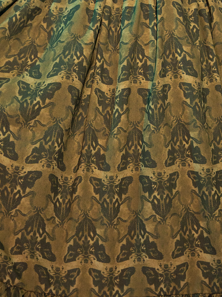 Shrouded in the enigmatic elegance of the olive-toned fabric, the Allerdale Moth Wallpaper Babydoll Dress captures the essence of gothic romance. The moth motifs, delicate yet daring, flutter across the dress, evoking a sense of intrigue and mystery. This piece is not just a garment; it's a gateway to a world where beauty intertwines with the macabre.