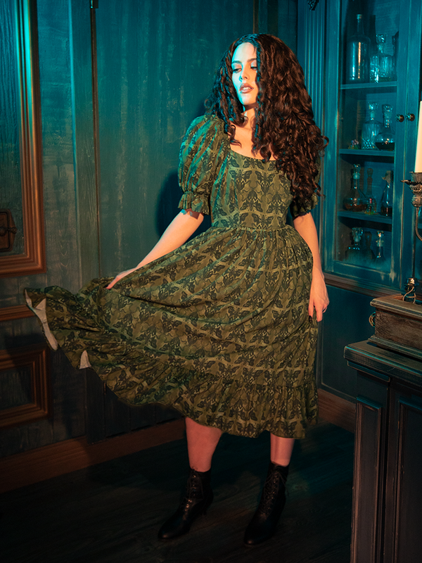 The Allerdale Moth Wallpaper Babydoll Dress, with its soft olive hue and haunting moth print, invites you into a gothic reverie. The babydoll cut, both innocent and provocative, whispers tales of forgotten mansions and secret gardens. Wearing this dress, you become part of a narrative that celebrates the beauty found in darkness.