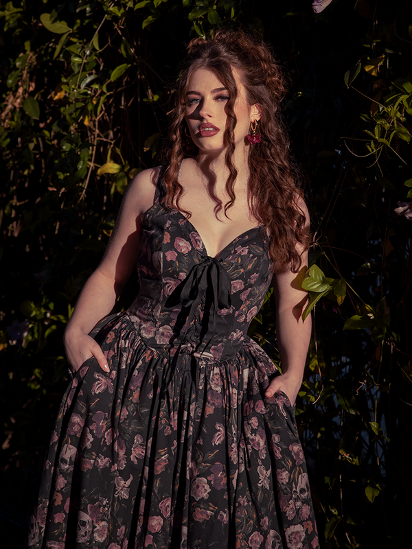 Like an apparition among ivy, she moves in silk shadows—Ambrosia’s dark florals fluttering like faded memories.