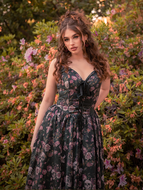 The auburn-haired vision fades into the foliage, her Ambrosia Dress a final whisper of elegance against the dark.