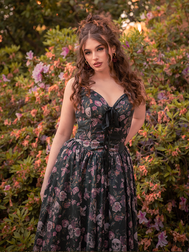 The auburn-haired vision fades into the foliage, her Ambrosia Dress a final whisper of elegance against the dark.
