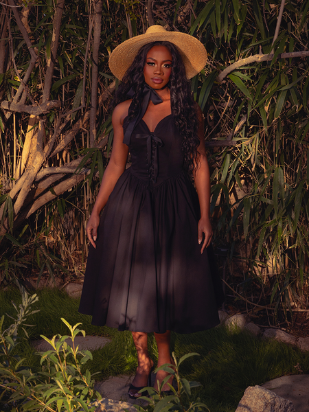 Step into timeless beauty with the Ambrosia Dress in Black. Its elegant silhouette and luxurious fabric create a captivating aura, perfect for twilight gatherings and moonlit dances.