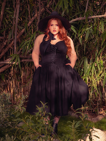 The Ambrosia Dress in Black is a darkly romantic creation. With its timeless design and luxurious fabric, it evokes the spirit of gothic poetry and forbidden love, perfect for candlelit soirées.