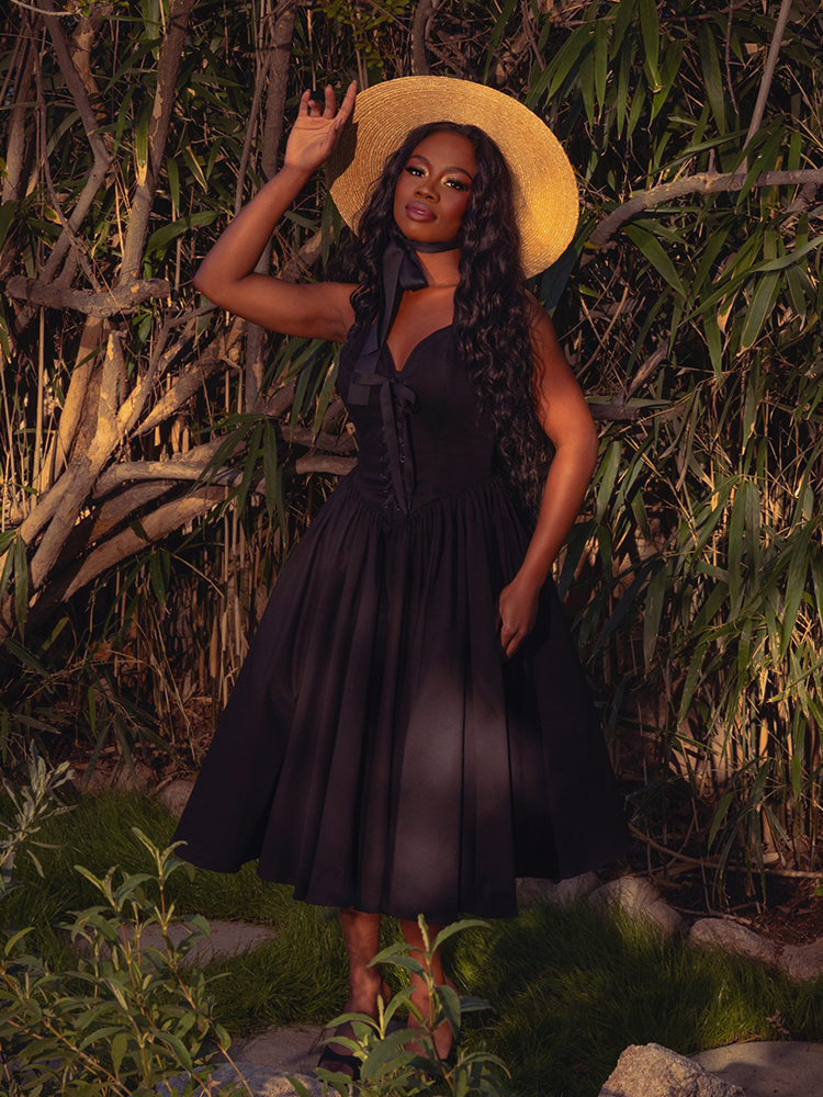 The Ambrosia Dress in Black is a vision of gothic allure. Its timeless design and flowing fabric evoke a sense of dark romance and mystery, ideal for candlelit evenings and whispered secrets.