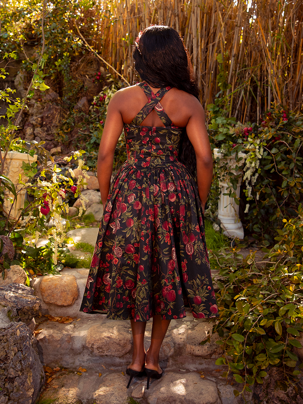 Indulge in the gothic allure of the Ambrosia Dress in Pomegranate Print. Its rich crimson hues and classic design evoke a sense of dark romance and mystery, perfect for twilight soirées and whispered secrets.