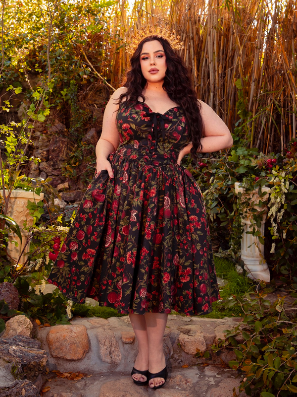 The Ambrosia Dress in Pomegranate Print is a masterpiece of gothic glamour. With its flowing fabric and elegant silhouette, it whispers tales of dark romance and forbidden love, perfect for candlelit evenings.