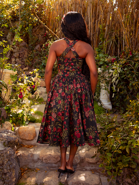 Indulge in the gothic allure of the Ambrosia Dress in Pomegranate Print. Its rich crimson hues and classic design evoke a sense of dark romance and mystery, perfect for twilight soirées and whispered secrets.