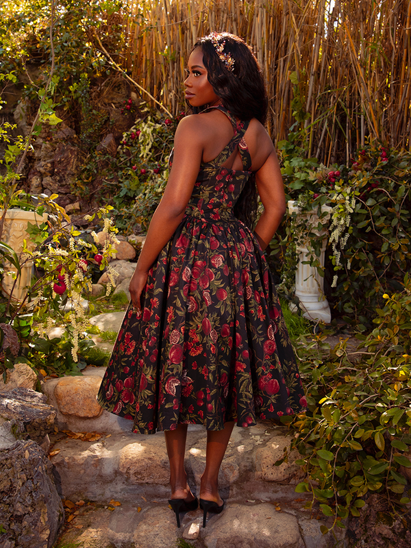 Step into gothic elegance with the Ambrosia Dress in Pomegranate Print. Its sleek silhouette and luxurious fabric create an air of timeless beauty, ideal for moonlit gatherings and midnight rendezvous.