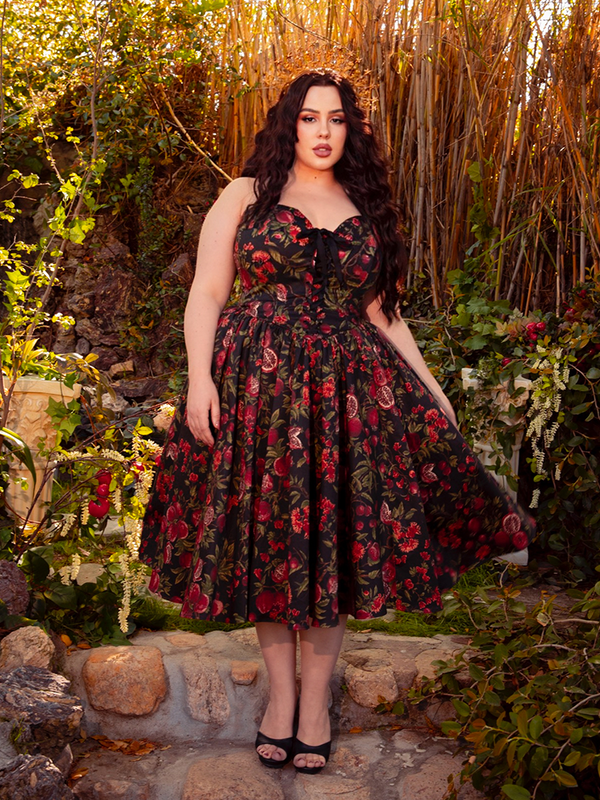 Wrap yourself in the dark romance of the Ambrosia Dress in Pomegranate Print. Its classic design and luxurious fabric make it ideal for evening galas and secret rendezvous, whispering tales of timeless beauty.