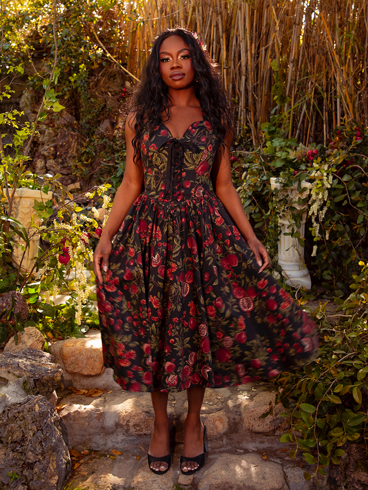 The Ambrosia Dress in Pomegranate Print is a masterpiece of gothic elegance. With its sleek silhouette and luxurious fabric, it whispers tales of dark romance and forbidden love, perfect for candlelit soirées.