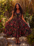 The Ambrosia Dress in Pomegranate Print is a darkly enchanting piece. Its rich crimson pattern and flowing fabric create a mesmerizing aura, perfect for evening galas and shadowy dances.