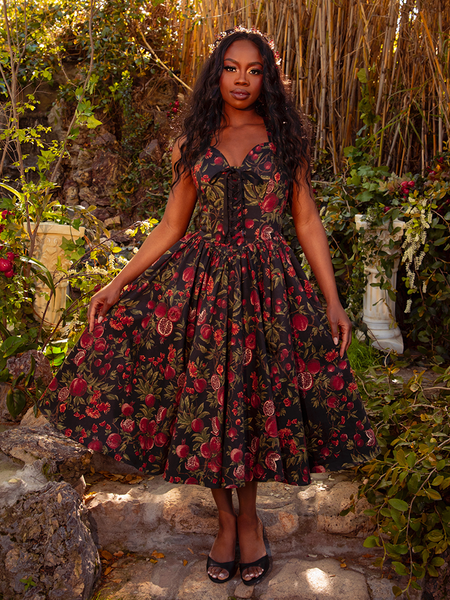 Wrap yourself in the allure of the Ambrosia Dress in Pomegranate Print. Its classic design and flowing fabric make it perfect for moonlit gatherings and shadowy dances, evoking a sense of timeless beauty.