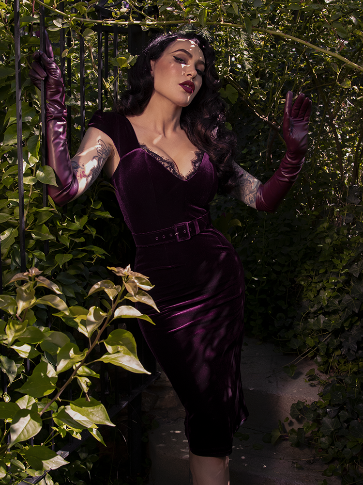 This plum-hued gothic dress hugs every curve like a forbidden secret, steeped in sultry sophistication and midnight allure.