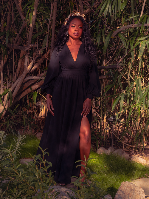 Embrace the timeless allure of the Belladonna Maxi Dress in Black. Crafted from luxurious, flowing fabric, this enchanting piece drapes you in gothic elegance. Perfect for moonlit soirées or midnight strolls, it promises to transform any occasion into a spellbinding event.