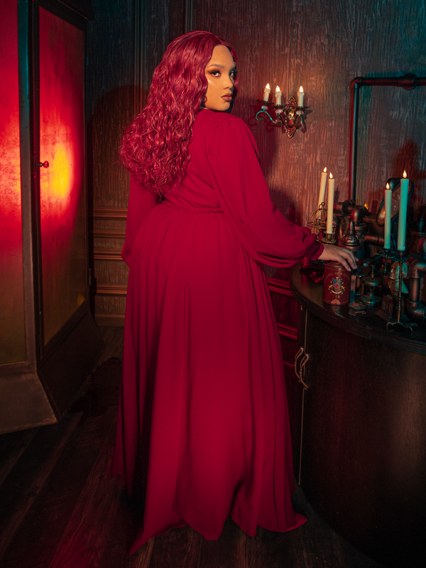 Portrait of a model in the Belladonna red maxi dress, focusing on the buttoned cuffs and the structured yet soft georgette fabric that defines gothic glamour women's wear.