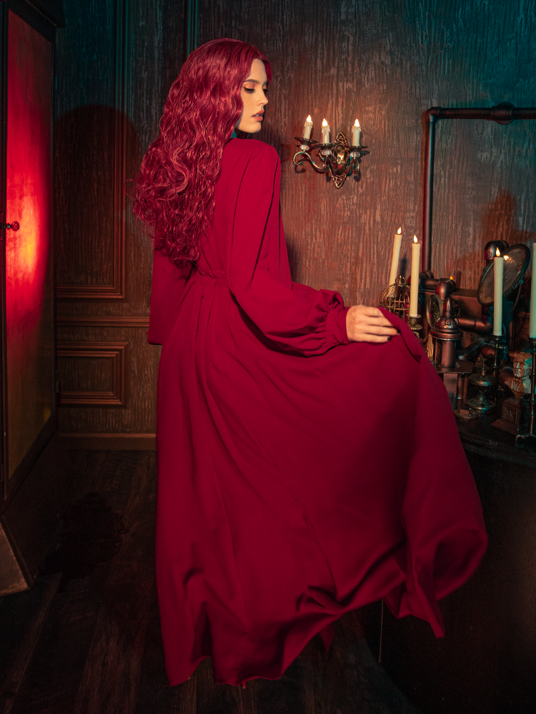 Detail shot of the deep side pockets hidden within the folds of the crimson red Belladonna maxi skirt, blending functional design with high-end gothic style clothing.