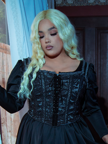 The Gothic Glamour Bustier in Black is the ultimate statement piece, designed with a structured bodice, satin panels, and delicate lace trim for a perfect blend of vintage allure and gothic charm.