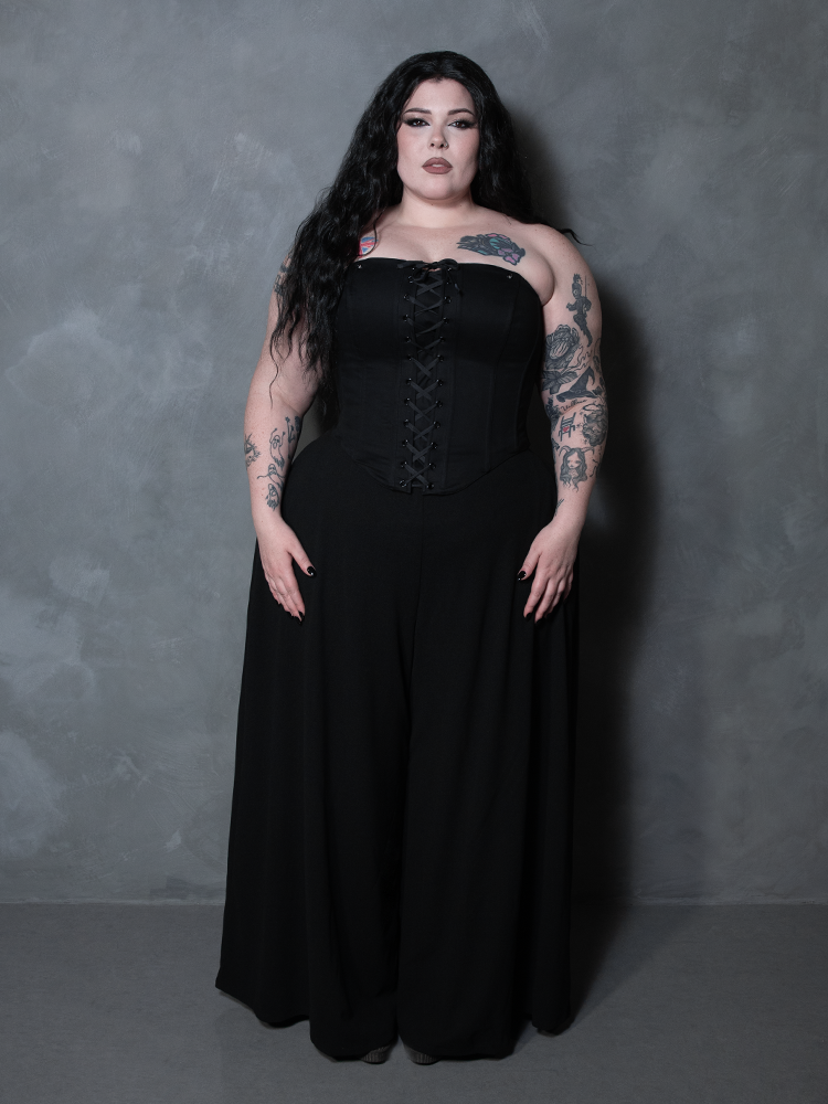 A female model embraces the mystical allure of Whimsigoth style, wearing a tailored black cotton corset.