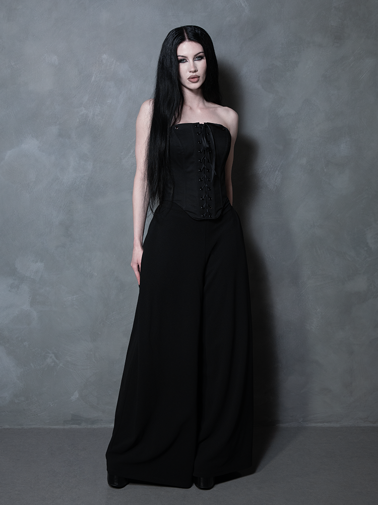 A female model demonstrates the powerful allure of gothic clothing, wearing a beautifully tailored black cotton corset.