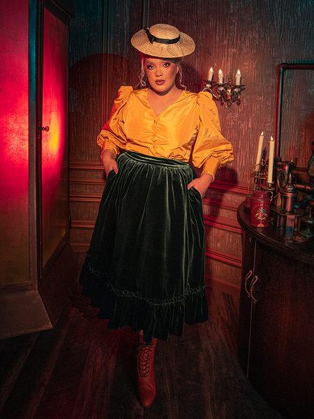 Step into the hauntingly beautiful world of La Femme en Noir as models reveal the Victorian Velvet Bustle Skirt in Olive with captivating allure.