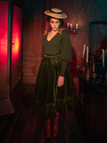 The gothic clothing brand La Femme en Noir shines as models showcase the hauntingly gorgeous Victorian Velvet Bustle Skirt in Olive.