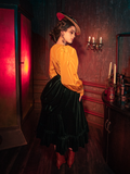 Mesmerizing the audience, models bring to life the hauntingly beautiful Victorian Velvet Bustle Skirt in Olive from the gothic clothing brand La Femme en Noir.
