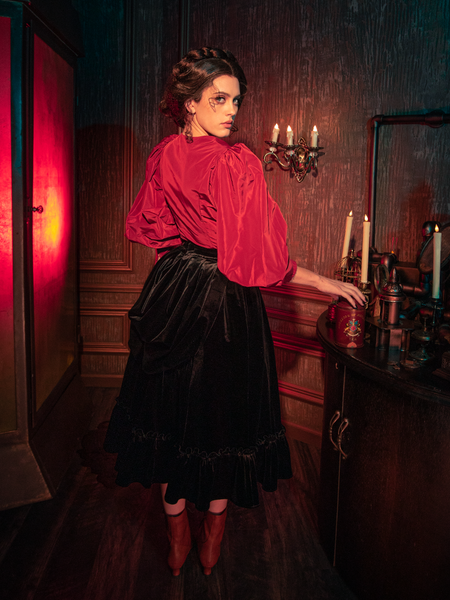 Witness the haunting elegance as models present La Femme en Noir's Victorian Velvet Bustle Skirt in Black, a piece that embodies gothic allure.
