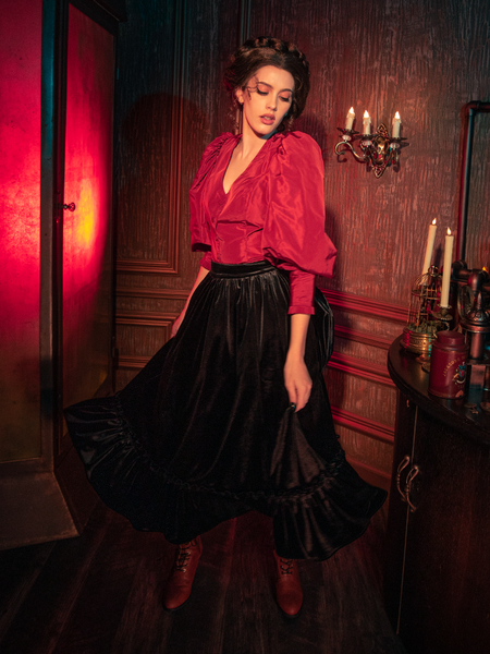 Explore the shadows with models flaunting the hauntingly beautiful Victorian Velvet Bustle Skirt in Black from the renowned gothic brand La Femme en Noir.