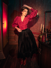 Step into the gothic realm with models showcasing the hauntingly beautiful Victorian Velvet Bustle Skirt in Black, a masterpiece by La Femme en Noir.