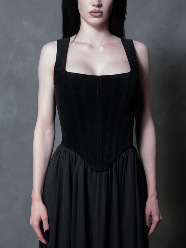 Model wearing a black velveteen corset top with Mythical Maxi georgette skirt against a gray background