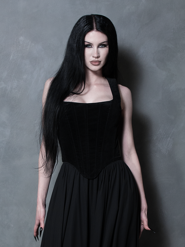 Model wearing a black velveteen corset top with Mythical Maxi georgette skirt against a gray background