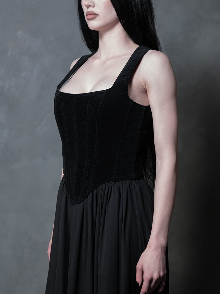 Front view of a model exuding gothic glamour in the Countess Corset, the plush black velvet creating a striking, structured silhouette of dark elegance.