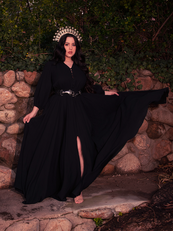 The gothic dress becomes a battle hymn when styled with boots — beauty armored in black.

