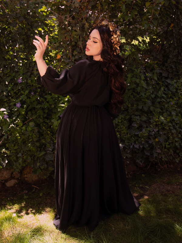 A cinched waist draws the eye, where structure meets mysticism in flattering embrace.