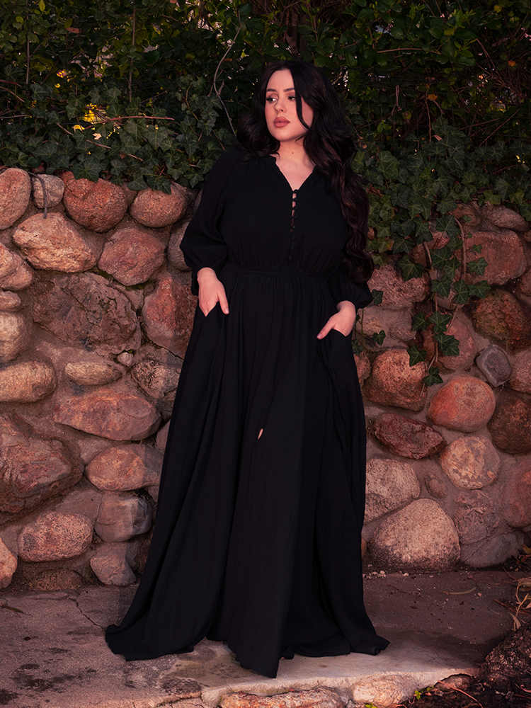 The gothic dress comes alive in the wind, casting a silhouette of storm-bound grace.