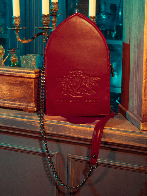 The CRIMSON PEAK™ Ghost Shoulder Bag from the gothic clothing brand La Femme en Noir is hauntingly displayed by captivating models.