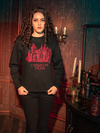 Step into the shadows with models showcasing the hauntingly gorgeous CRIMSON PEAK™ Allerdale Hall Sweatshirt in Black, a masterpiece from the gothic clothing brand La Femme en Noir.