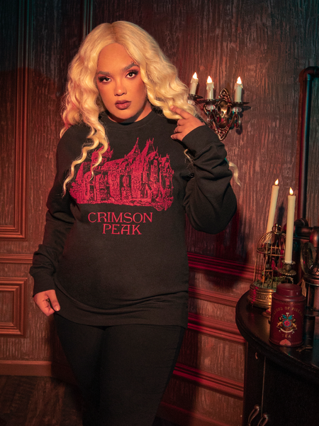 Witness the allure of the hauntingly gorgeous CRIMSON PEAK™ Allerdale Hall Sweatshirt in Black as models bring it to life for La Femme en Noir, the gothic clothing brand.