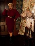 With its flattering high-waisted cut and deep oxblood hue, the Vamp Pencil Skirt is a bold yet timeless piece that embodies vintage-inspired sophistication.