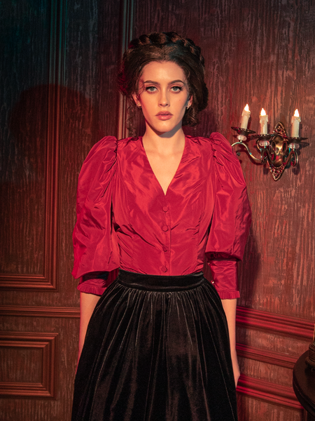 The Taffeta Edwardian Blouse in Crimson Red is elegantly modeled by gothically gorgeous female models, portraying its allure through various poses.