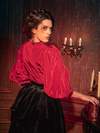 Modeling the Taffeta Edwardian Blouse in Crimson Red, gothically gorgeous female models captivate with their diverse poses.