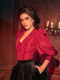Gothically stunning female models showcase the Taffeta Edwardian Blouse in Crimson Red, striking a variety of captivating poses.