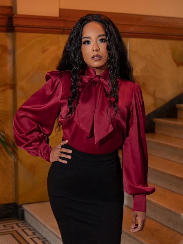 With a sweeping bow and billowing sleeves, this crimson masterpiece evokes a heroine’s grace, perfect for moonlit soirées or grand salons.