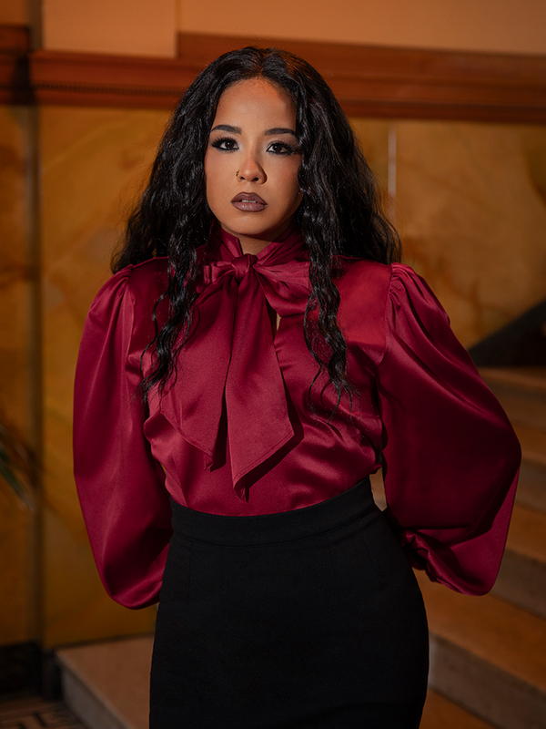 Bathed in candlelight allure, the Victorian Blouse in Crimson Red radiates power and poise—each satin fold a whisper of forbidden romance.