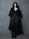 Radiating pure gothic glamour, a female model brings a hauntingly beautiful black satin romance gown to life.